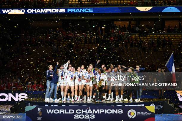 France's team celebrates on the podium after winning the gold medal after the final match between France and Norway of the IHF World Women's Handball...