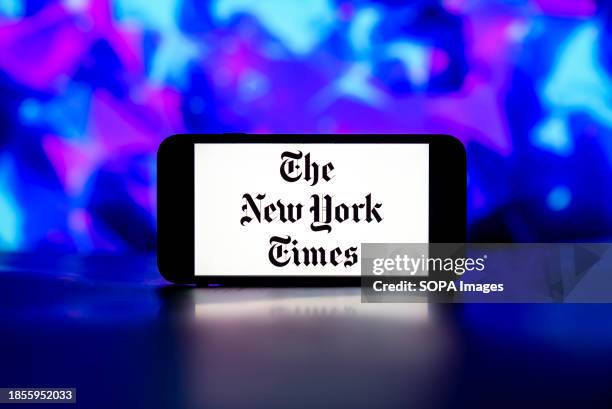 In this photo illustration, the New York Times logo is seen displayed on a mobile phone screen.