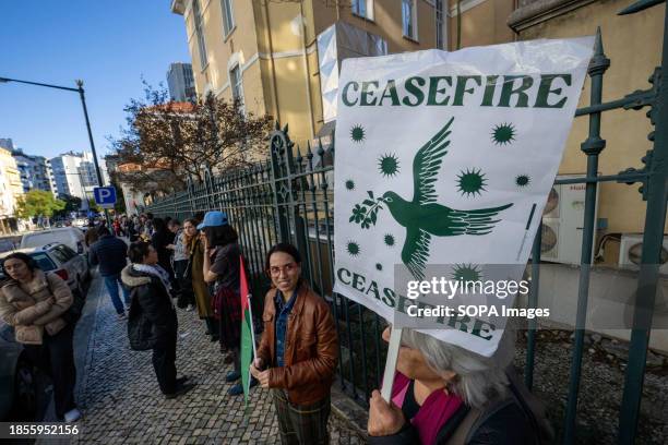 An activist holds a banner during a demonstration near the Israeli embassy. The protest actions were organized by PUSP - Plataforma Unitária de...