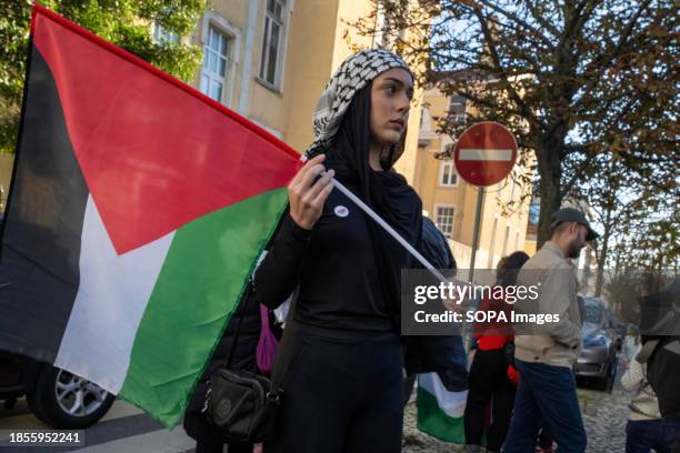 An activist holds a Palestinian flag demonstration near the Israeli embassy. The protest actions were organized by PUSP - Plataforma Unitária de...