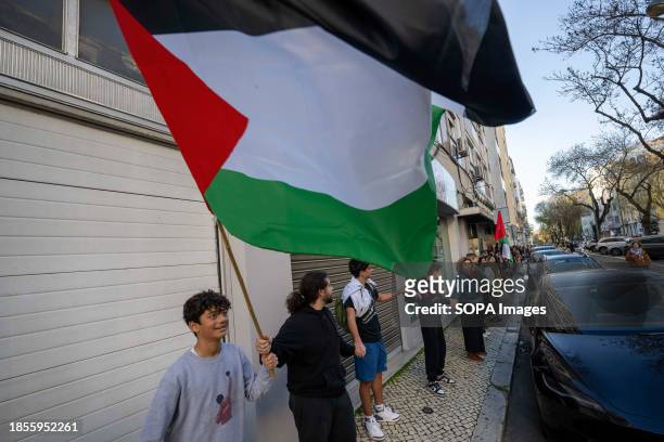 An activist holds a Palestinian flag demonstration near the Israeli embassy. The protest actions were organized by PUSP - Plataforma Unitária de...