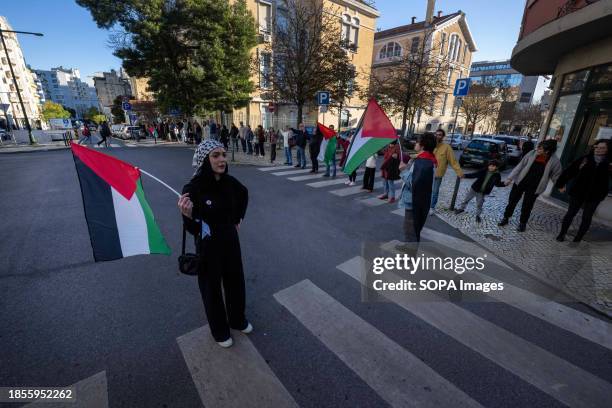 Activists hold Palestinian flags during a demonstration near the Israeli embassy. The protest actions were organized by PUSP - Plataforma Unitária de...