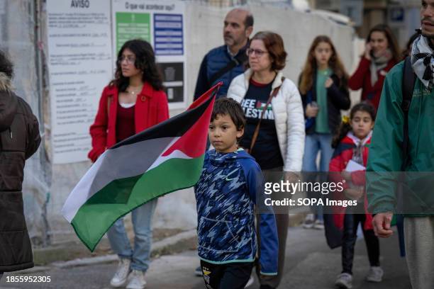 Boy waves a Palestinian flag during a demonstration near the Israeli embassy. The protest actions were organized by PUSP - Plataforma Unitária de...