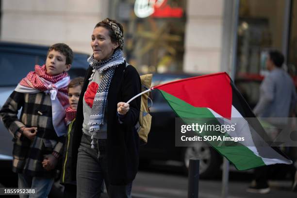 Woman holding a Palestinian flag walks with children during a demonstration near the Israeli embassy. The protest actions were organized by PUSP -...