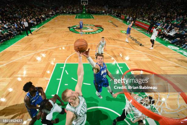 Sam Hauser of the Boston Celtics and Moritz Wagner of the Orlando Magic go up for the rebound during the game on December 17, 2023 at the TD Garden...