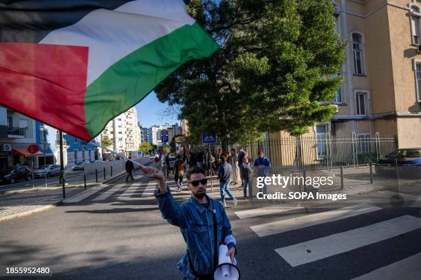 An activist waves a Palestinian flag during a demonstration near the Israeli embassy. The protest actions were organized by PUSP - Plataforma...