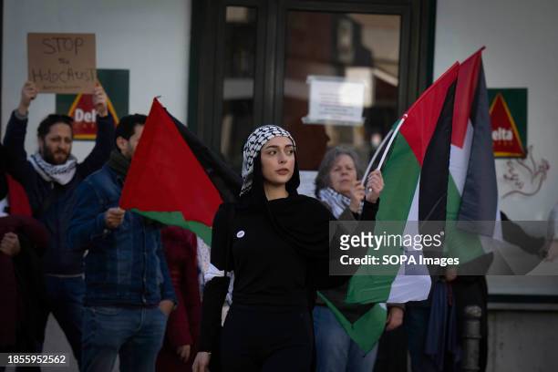 Activists hold Palestinian flags during a demonstration near the Israeli embassy. The protest actions were organized by PUSP - Plataforma Unitária de...