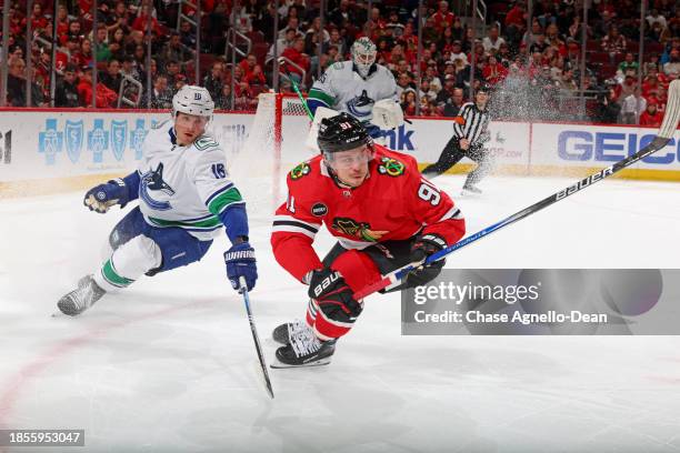 Anthony Beauvillier of the Chicago Blackhawks skates ahead of Sam Lafferty of the Vancouver Canucks in the second period at the United Center on...