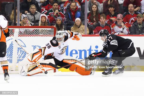 Anaheim Ducks goaltender John Gibson makes a save on New Jersey Devils defenseman Simon Nemec during a game between the Anaheim Ducks and New Jersey...