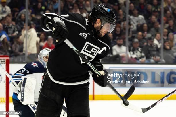 Los Angeles, CA Kings center Anze Kopitar battles Winnipeg Jets defenders for control of the puck at Crypto.com Arena in Los Angeles Wednesday, Dec....