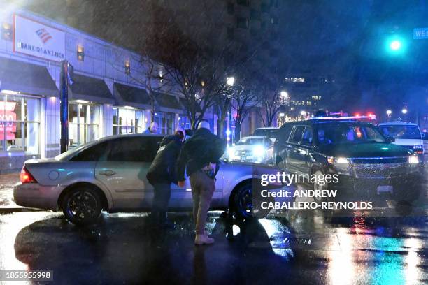 Members of the US Secret Service rush to a car, after it hit a motorcade SUV, as US president Joe Biden was leaving his campaign headquarters in...