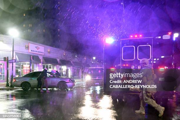 Members of the US Secret Service rush to a car, after it hit a motorcade SUV, as US president Joe Biden was leaving his campaign headquarters in...