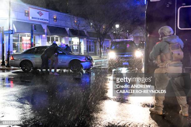 Members of the US Secret Service rush to a car, after it hit a motorcade SUV, as US president Joe Biden was leaving his campaign headquarters in...