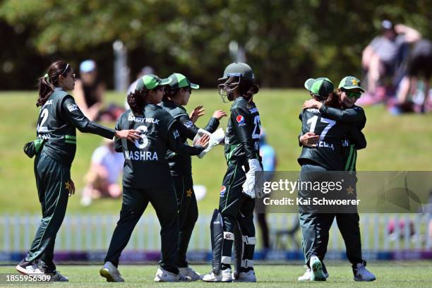 Nashra Sandhu of Pakistan is congratulated by team mates after dismissing Suzie Bates of New Zealand during game three of the Women's ODI series...