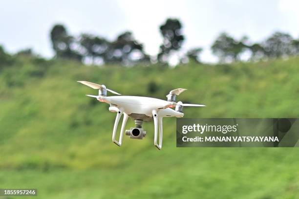 This picture taken on November 22, 2023 shows a drone being flown by Chiang Mai University's Forest Restoration Research Unit field research officer...