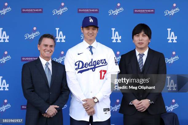 Shohei Ohtani poses for a photo with his interpreter Ippei Mizuhara and agent Nez Balelo after being introduced by the Los Angeles Dodgers at Dodger...