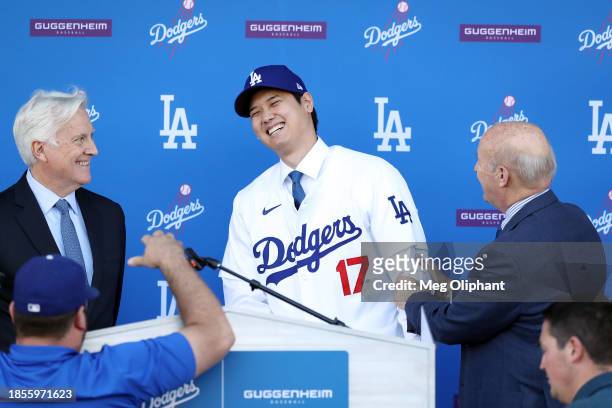 Shohei Ohtani speaks with Mark Walter, Dodgers Owner and Chairman, and Stan Kasten, Dodgers President and CEO, at Dodger Stadium on December 14, 2023...