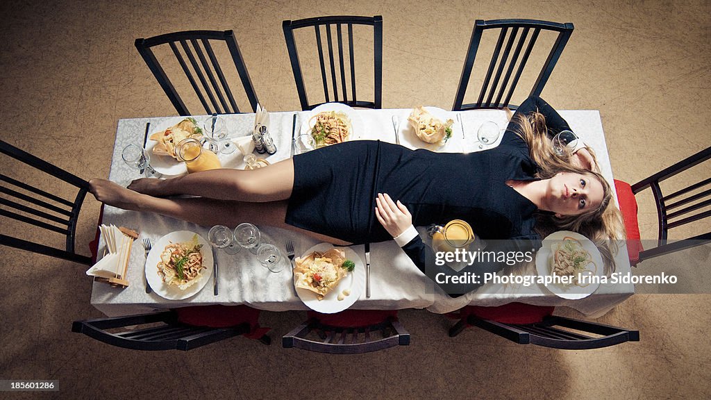 Women is on the table among the dish