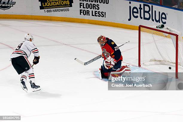 Jonathan Toews of the Chicago Blackhawks scores a shoot-out goal past goaltender Jacob Markstrom of the Florida Panthers at the BB&T Center on...