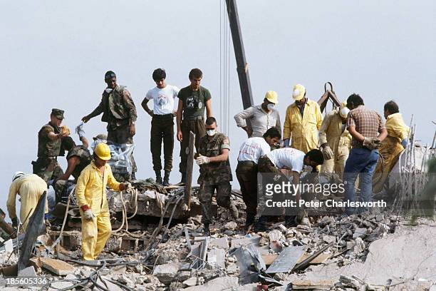 American Marines search for survivors and bodies in the rubble, all that was left of their barracks head quarters in Beirut, after a terrorist...