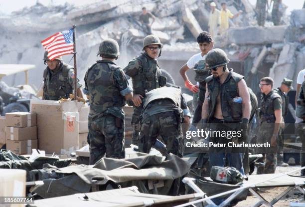 American Marines search for survivors and bodies in the rubble, all that was left of their barracks head quarters in Beirut, after a terrorist...