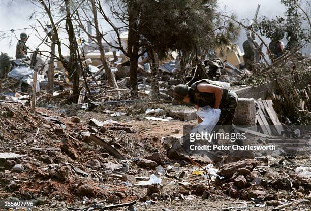 American Marines search for survivors and bodies in the rubble, all that was left of their barracks head quarters in Beirut, after a terrorist...