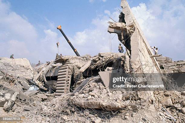 American Marines search for survivors and bodies in the rubble, all that was left of their barracks head quarters in Beirut, after a terrorist...