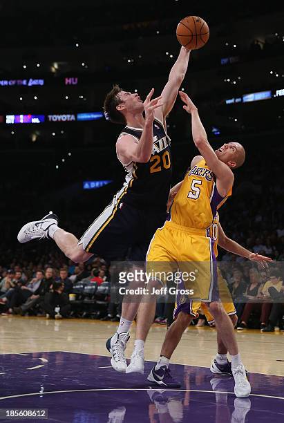 Gordon Hayward of the Utah Jazz and Steve Blake of the Los Angeles Lakers fight for a loose ball in the first half at Staples Center on October 22,...