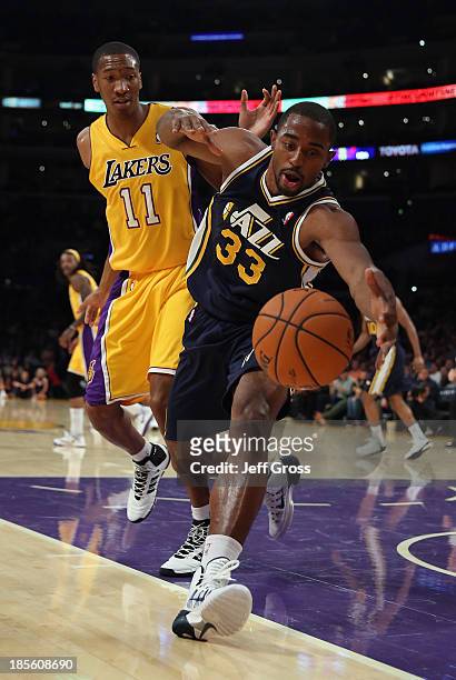 Mike Harris of the Utah Jazz lunges for a loose ball while defended by Wesley Johnson of the Los Angeles Lakers in the first half at Staples Center...