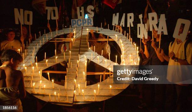 Anti-war protestors hold a candlelight vigil outside the U.S. Embassy March 18, 2003 in Manila, Philippines. Hours after Bush's televised address...