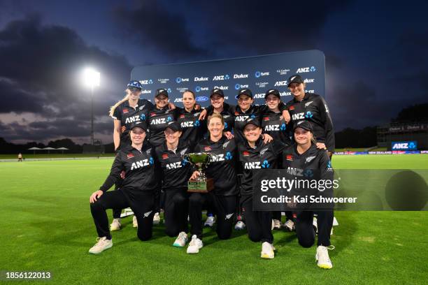 Captain Sophie Devine of New Zealand and her teammates celebrate with the series trophy following game three of the Women's ODI series between New...