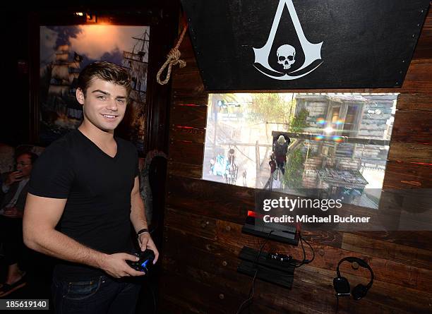 Actor Garrett Clayton playing the Sony Playstation 4 at the Assasin's Creed IV Black Flag Launch Party at Greystone Manor Supperclub on October 22,...