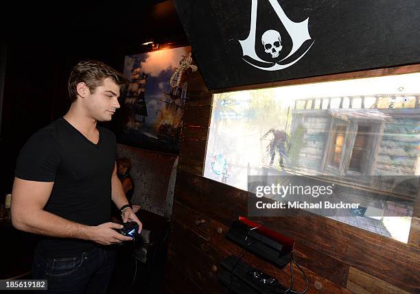 Actor Garrett Clayton playing the Sony Playstation 4 at the Assasin's Creed IV Black Flag Launch Party at Greystone Manor Supperclub on October 22,...