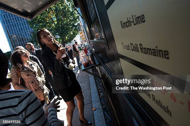 Shimika Wilder places and order for lunch from a food truck in Farragut Square in Washington, DC on October 18, 2013. Wilder said she used to be anti...