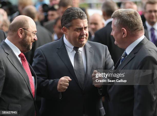 Sigmar Gabriel , Chairman of the German Social Democrats , arrives with SPD member Martin Schulz for coalition negotiations as he greets Hermann...