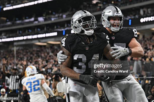 Running back Brandon Bolden of the Las Vegas Raiders celebrates after scoring a touchdown with teammate tight end Michael Mayer against the Los...