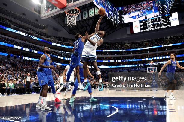 Anthony Edwards of the Minnesota Timberwolves grabs a rebound against Derrick Jones Jr. #55 of the Dallas Mavericks in the first half at American...