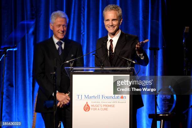 President of Entertainment Enterprises at Clear Channel John Sykes accepts the Lifetime Music Industry Award onstage with President Bill Clinton at...