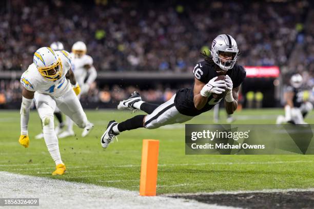 Jakobi Meyers of the Las Vegas Raiders completes a pass for a touchdown against Michael Davis of the Los Angeles Chargers during an NFL football game...