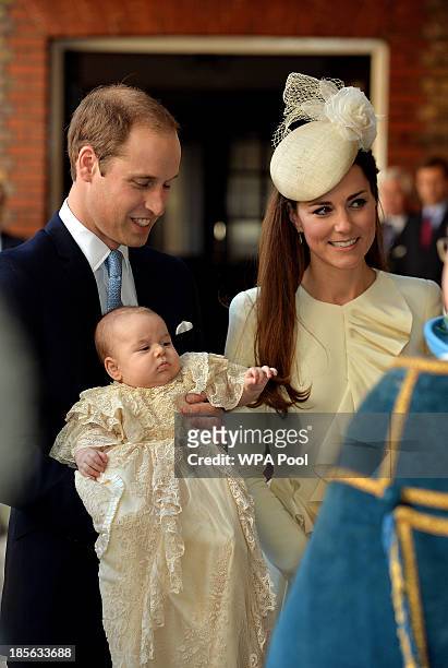 Prince William, Duke of Cambridge and Catherine, Duchess of Cambridge arrive, holding their son Prince George, at Chapel Royal in St James's Palace,...