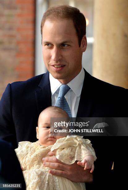 Britain's Prince William, Duke of Cambridge holds his son, Prince George of Cambridge, as he arrives at Chapel Royal in St James's Palace in central...
