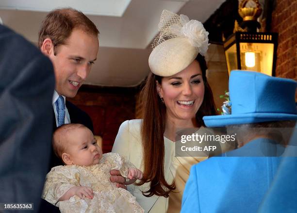 Britain's Prince William, Duke of Cambridge and his wife Catherine, Duchess of Cambridge, speak with Queen Elizabeth II as they hold their son Prince...