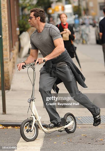 Actor Hugh Jackman is seen riding a scooter in the West Village on October 23, 2013 in New York City.