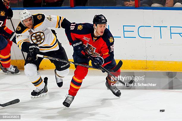 Shawn Matthias of the Florida Panthers skates for the puck against Dennis Seidenberg of the Boston Bruins at the BB&T Center on October 17, 2013 in...