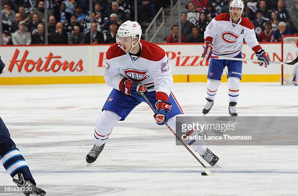 Alex Galchenyuk of the Montreal Canadiens carries the puck up the ice during third period action against the Winnipeg Jets at the MTS Centre on...