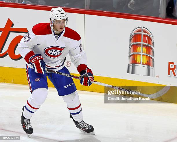 Alex Galchenyuk of the Montreal Canadiens keeps an eye on the play during first period action against the Winnipeg Jets at the MTS Centre on October...