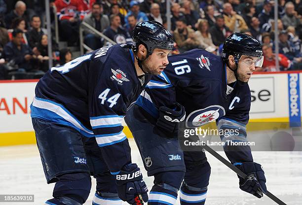 Zach Bogosian and Andrew Ladd of the Winnipeg Jets get set for a third period face-off against the Montreal Canadiens at the MTS Centre on October...