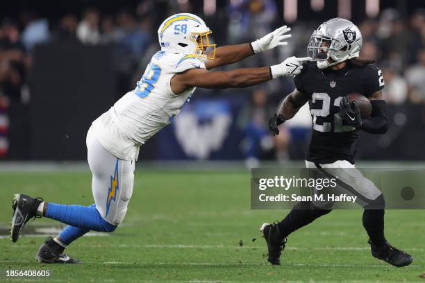 Running back Ameer Abdullah of the Las Vegas Raiders rushes in front of linebacker Justin Hollins of the Los Angeles Chargers during the second half...