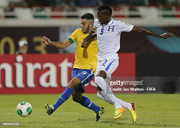 Anoal Hernandez of Honduras tries to tackle Mosquito of Brazil during the Group A, FIFA U-17 World Cup match between Honduras and Brazil at Ras Al...