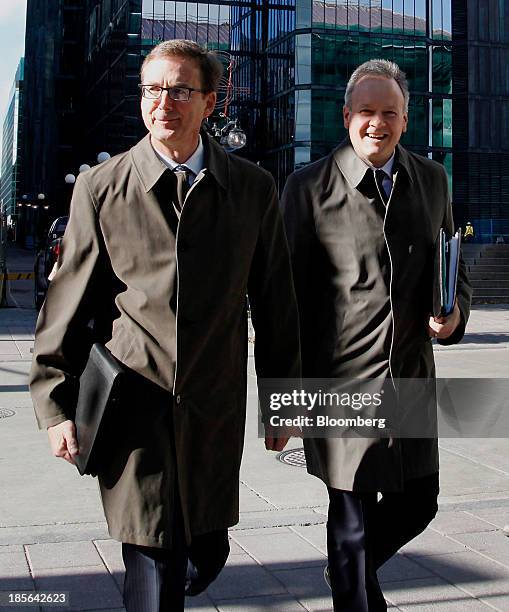 Stephen Poloz, governor of the Bank of Canada, right, and Tiff Macklem, senior deputy governor of the Bank of Canada, cross Bank Street before...